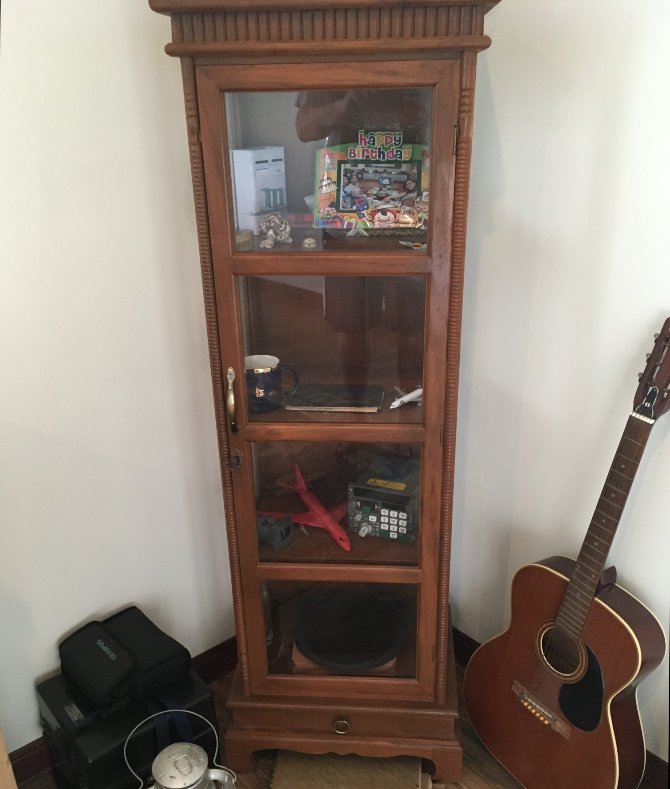 Curio cabinet with model airplane