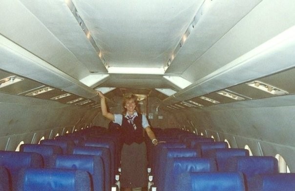 Flight attendant in airplane cabin