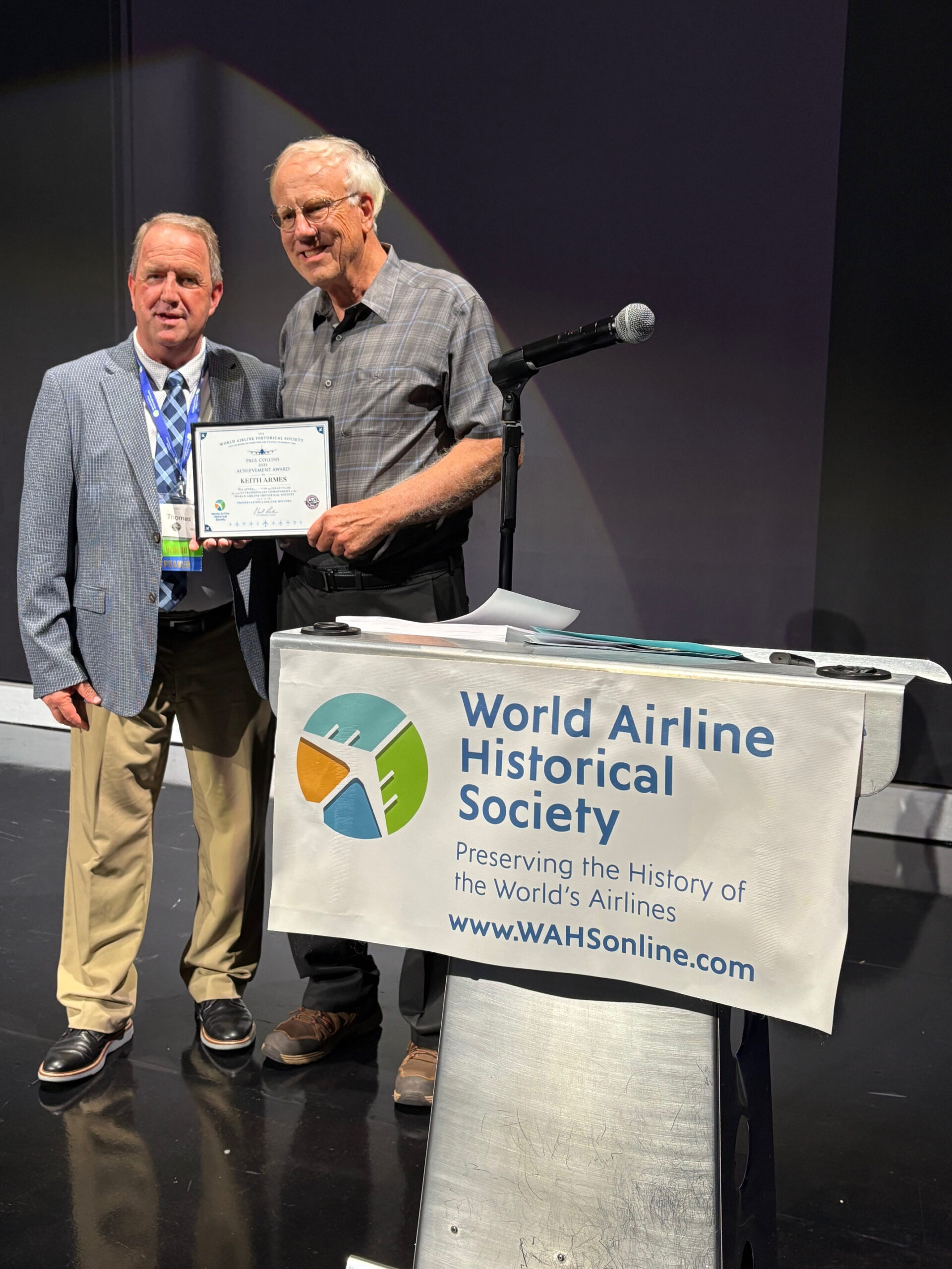 Keith Armes receives the 2025 Paul Collins Award from Tom Livesey